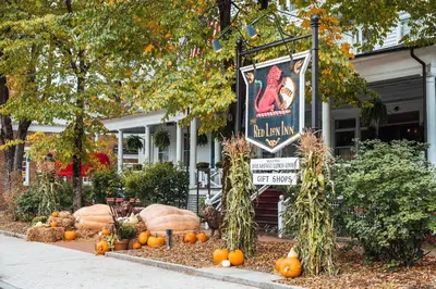 a display of pumpkins and a sign in front of a building at The Red Lion Inn in Stockbridge
