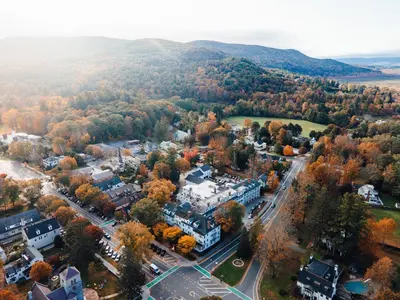 an aerial view of a town with trees and buildings at The Red Lion Inn in Stockbridge