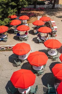 a group of tables with red umbrellas at The Red Lion Inn in Stockbridge