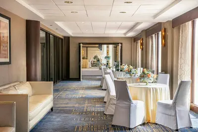 a row of tables and chairs in a restaurant at Sheraton LaGuardia East Hotel in Queens