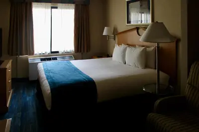 a hotel room with a large bed and a window at Marco LaGuardia Hotel & Suites in Queens