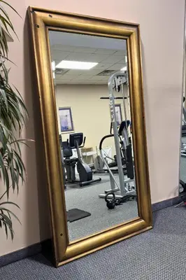 a mirror in a gym with exercise equipment at Marco LaGuardia Hotel & Suites in Queens