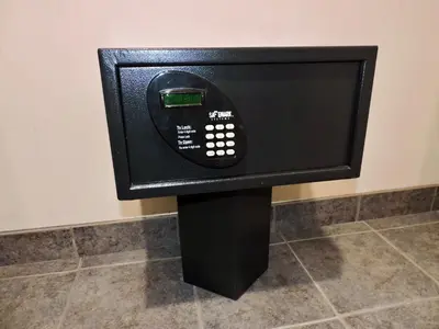 a black tv on a stand in a room at Marco LaGuardia Hotel & Suites in Queens