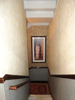 a hallway with a painting of a woman on the wall at Hotel 31 Extended Stay in New York