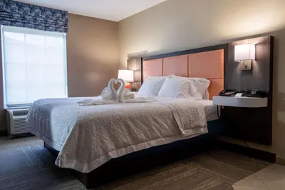 a hotel room with a large bed and a window at Hampton Inn Hadley-Amherst Area in Hadley