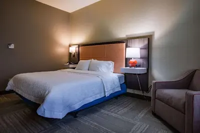 a hotel room with a bed and a chair at Hampton Inn Hadley-Amherst Area in Hadley