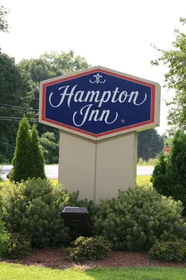 a sign for a hampton inn sitting in the grass at Hampton Inn Hadley-Amherst Area in Hadley