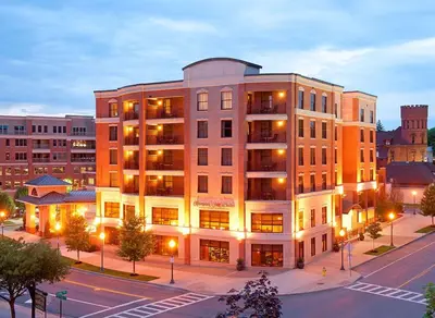 a building on the corner of a street in a city at Hampton Inn & Suites Saratoga Springs Downtown in Saratoga Springs