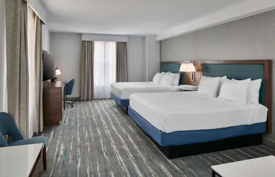 a hotel room with two beds and a television at Hampton Inn & Suites Saratoga Springs Downtown in Saratoga Springs