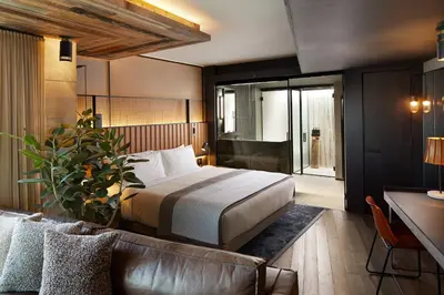 a hotel room with a bed and a couch at 1 Hotel Brooklyn Bridge in Brooklyn