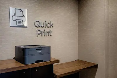 a printer sitting on top of a wooden table at Courtyard by Marriott Albany Clifton Park in Clifton Park