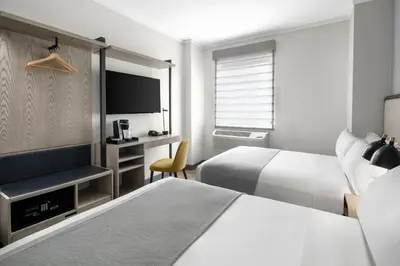 a hotel room with two beds and a television at Citadines Connect Fifth Avenue New York in New York