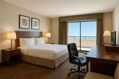 a hotel room with a bed and a desk and a computer at LIC Manhattan View Hotel in Queens