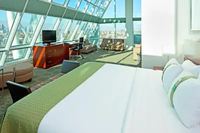 a bedroom with a bed and a tv in a building at LIC Manhattan View Hotel in Queens