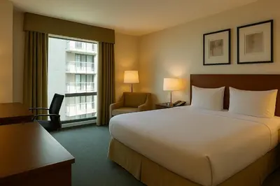 a hotel room with a large bed and a window at LIC Manhattan View Hotel in Queens