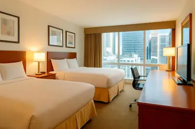 a hotel room with two beds and a window at LIC Manhattan View Hotel in Queens