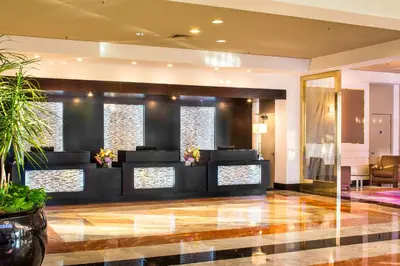 a lobby of a hotel with a reception desk at DoubleTree by Hilton New York-LaGuardia in Queens