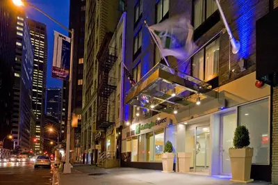a building on a city street at night at Holiday Inn Express - Wall Street by IHG in New York