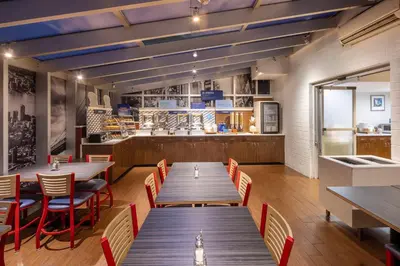 a restaurant with wooden tables and chairs and a counter at Holiday Inn Express - Times Square by IHG in New York