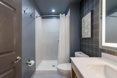 a bathroom with a white toilet and a sink at Ardsley Acres Hotel Court in Ardsley