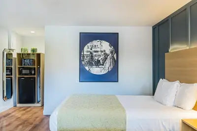 a hotel room with a bed and a picture on the wall at Ardsley Acres Hotel Court in Ardsley
