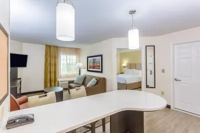 a hotel suite with a living room and a bedroom at Candlewood Suites Secaucus by IHG in Secaucus