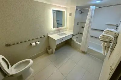 a bathroom with a toilet and a sink at Country Inn & Suites by Radisson, Downtown Albany New York in Albany