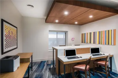 an office with a desk with two computers on it at Country Inn & Suites by Radisson, Downtown Albany New York in Albany