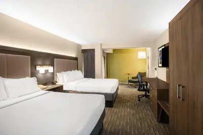 a hotel room with two beds and a desk at Country Inn & Suites by Radisson, Downtown Albany New York in Albany