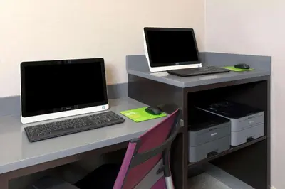 a desk with two laptop computers on top of it at La Quinta by Wyndham New York City Central Park in New York