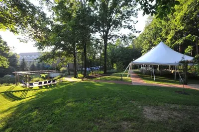 a white tent in a park with a grass field at Avon Old Farms Hotel in Avon