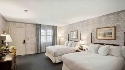 a hotel room with two beds and a window at Avon Old Farms Hotel in Avon