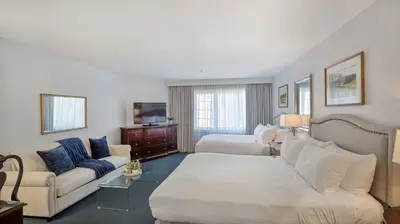 a living room with a couch and a bed and a living room at Avon Old Farms Hotel in Avon