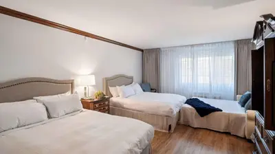 a hotel room with two beds and a window at Avon Old Farms Hotel in Avon
