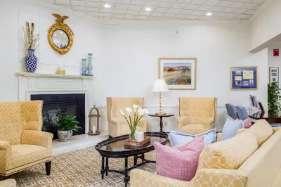 a living room with a couch and chairs and a fireplace at The Farmington Inn and Suites in Farmington