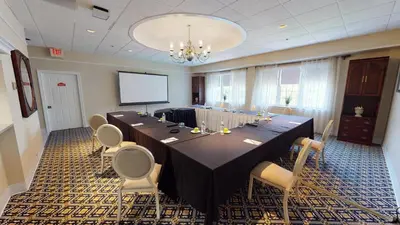 a large conference room with a long table and chairs at The Simsbury Inn in Simsbury