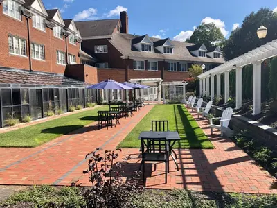 a courtyard with tables and chairs in a building at The Simsbury Inn in Simsbury