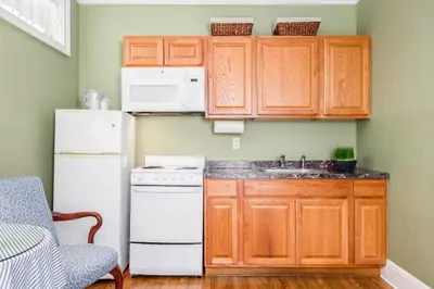 a kitchen with a white refrigerator and a sink at Simsbury 1820 House in Simsbury