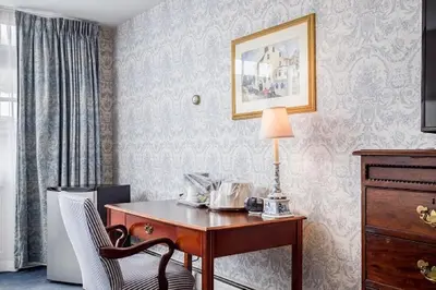 a room with a desk with a lamp and a chair at Simsbury 1820 House in Simsbury