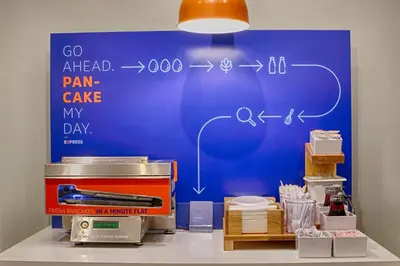 a blue wall with a drawing of a pain cave on it at Holiday Inn Express & Suites East Greenbush Albany-Skyline by IHG in Rensselaer