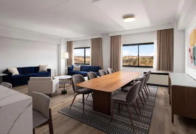 a living room with a table and chairs at Sonesta White Plains Downtown in White Plains