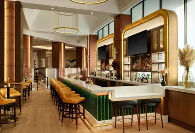 a bar in a restaurant with brown stools at Sonesta White Plains Downtown in White Plains