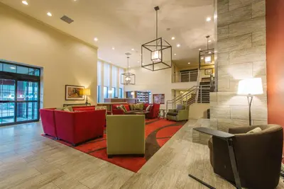 a lobby with couches and chairs and a staircase at Hotel MTK Mount Kisco in Mount Kisco
