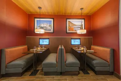 a dining room with two tables and two chairs at Hotel MTK Mount Kisco in Mount Kisco
