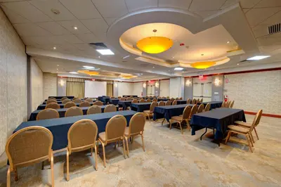 a conference room with tables and chairs in it at Holiday Inn Plainview-Long Island by IHG in Plainview