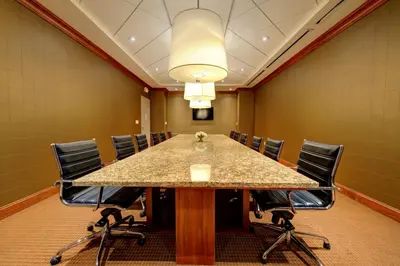a conference room with a large table and chairs at Holiday Inn Plainview-Long Island by IHG in Plainview