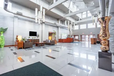 a lobby of a building with a large white tile floor at Holiday Inn Plainview-Long Island by IHG in Plainview