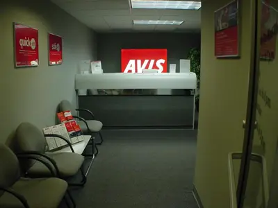a waiting room with aavis sign on the wall at Holiday Inn Westbury-Long Island by IHG in Carle Place