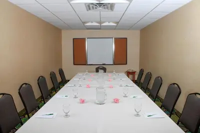 a conference room with a long table and chairs at Holiday Inn Westbury-Long Island by IHG in Carle Place