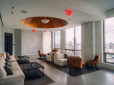 a living room with a couch and a table at Hotel 50 Bowery, part of JdV by Hyatt in New York